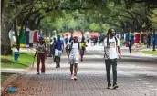  ?? Mark Mulligan / Staff photograph­er ?? Students walk through the campus of Texas Southern University in Houston.