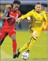  ?? AP PHOTO ?? Toronto FC’s Tosaint Ricketts (left) and Columbus Crew’s Artur chase a loose ball during an MLS Eastern Conference championsh­ip soccer match Tuesday in Columbus, Ohio.