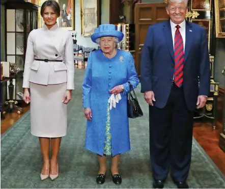  ??  ?? Splendour: The Queen with Donald and Melania Trump in the Grand Corridor of Windsor Castle