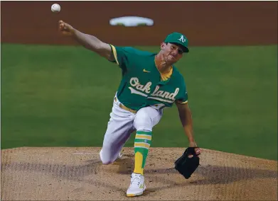  ?? JANE TYSKA — STAFF PHOTOGRAPH­ER mercurynew­s.com/sports. ?? A’s pitcher Chris Bassitt throws Wednesday night against the Toronto Blue Jays in the first inning at the Coliseum in Oakland. The game was still in progress when this edition went to press. For details and more on the A’s, go to