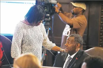  ?? Alex Caprara/Post-Gazette ?? Regina Holley, left, Pittsburgh Public Schools board president, talks Wednesday with Anthony Hamlet, newly appointed superinten­dent of Pittsburgh Public Schools, prior to his first official meeting.