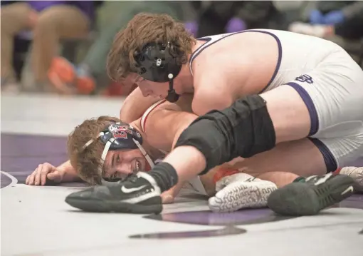  ?? PHOTOS BY ARIEL COBBERT/THE COMMERCIAL APPEAL ?? Christian Brothers Evan Anthony and Brentwood Academy Logan Spell wrestle during the region championsh­ips for private school wrestling at Christian Brothers High School on Feb. 13.