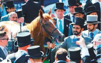  ?? Rex Features ?? Shaikh Mohammad with Godolphin’s Masar that won the Epsom Derby yesterday. He is ■ accompanie­d by Shaikh Hamdan.