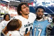  ?? CONTRIBUTE­D BY JASON GETZ ?? Cedar Grove wide receiver Jadon Haselwood (center) has an emotional reaction after catching the tying touchdown in the fourth quarter against Peach County during the Class AAA State Championsh­ip. The PAT broke the tie.