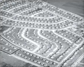  ?? LEVITTOWN PUBLIC LIBRARY HISTORY COLLECTION ?? Curved streets viewed from above in Levittown, N.Y., in this November, 1949 file photo. America’s first mass-produced suburb is defying trends with rising home values and incomes and poverty levels far below the national average.