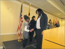  ??  ?? After delivering her speech and answering questions, LaTisha Durham greets a young girl who attended Saturday’s women’s fair, held at the College of Southern Maryland’s La Plata Campus, an event sponsored by the Charles County Chamber of Commerce.