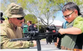  ?? Photo / Ilona Hanne ?? Blake Stieller-Caley, 6, has a close look at a Mars-L, while Officer Cadet Morris looks on.