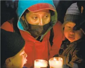  ?? CARLOS MORENO FOR THE U-T ?? Migrants gathered in Tijuana near the San Ysidro Port of Entry on May 22 to hold a candleligh­t vigil protesting U.S. policies that they say put asylum seekers at risk.