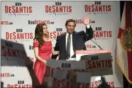  ?? PHELAN M. EBENHACK — THE ASSOCIATED PRESS ?? Florida Republican gubernator­ial candidate Ron DeSantis, right, waves to supporters with his wife, Casey, at an election party after winning the Republican primary, Tuesday in Orlando, Fla.