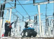  ?? SONG WEIXING / FOR CHINA DAILY ?? A robot helps check power transmissi­on facilities in Quanjiao county, Anhui province.