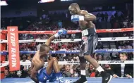  ?? AP ?? Terence Crawford stands over Julius Indongo after a punch brought him down in the second round of a junior welterweig­ht world title unificatio­n bout in Lincoln, Nebraska, on Saturday. Crawford won by knockout during the third round.