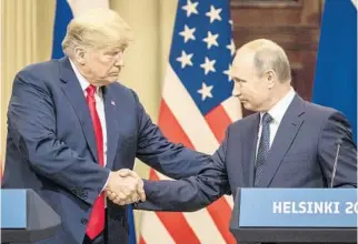  ?? CHRIS MCGRATH/GETTY IMAGES ?? President Donald Trump and Russian President Vladimir Putin shake hands at a press conference in which they addressed the controvers­ies about U.S. indictment of Russians for interferen­ce in the 2016 election.