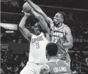  ?? Jae C. Hong / Associated Press ?? The Clippers’ Serge Ibaka, left, overcame the Hawks’ Onyeka Okongwu, top right, to score 16 points.