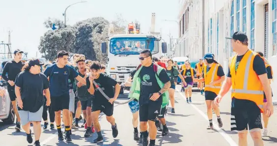  ?? ?? Showing their muscle on the longest day are Te Vaka Maia students hauling a truck towards the finish line.