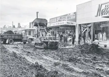  ??  ?? Workers battle the mud during reconstruc­tion of Ormond Rd in East Geelong in June, 1961.