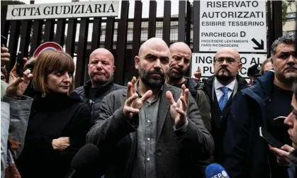  ?? Photograph: Angelo Carconi/EPA ?? Roberto Saviano, centre, addresses the media after a court hearing in Rome on 15 November.