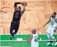  ?? ASSOCIATED PRESS ?? LeBron James soars to the rim for a two-handled slam as Al Horford (42) and Marcus Morris look on during Game 7 of the East finals.