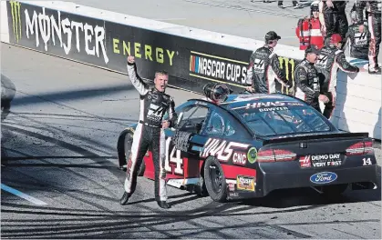  ?? JERRY MARKLAND GETTY IMAGES ?? Clint Bowyer celebrates winning the weather-delayed Monster Energy NASCAR Cup Series STP 500 at Martinsvil­le Speedway in Martinsvil­le, Va., on Monday.