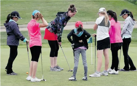  ?? LARRY WONG/EDMONTON JOURNAL ?? Junior golfers get lessons from Jeneth McElroy during a CN Future Links girls’ clinic at the Glendale Golf & Country Club.