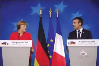  ??  ?? German Chancellor Angela Merkel and French President Emmanuel Macron prepare to address the media at an EU summit in Brussels on June 23, 2017. — AP