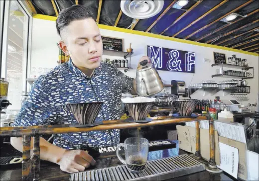  ?? BILL HUGHES/LAS VEGAS REVIEW-JOURNAL ?? Josh Molina, co-owner of Makers and Finders, prepares coffee in the shop at 1120 S. Main St. in downtown Las Vegas