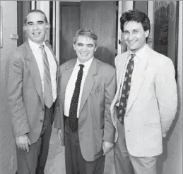  ?? Robert Gabriel
Los Angeles Times ?? TELEVISION, FILM DIRECTOR Michael Campus, left, Soviet writer Alexander Gelman and producer Derek Hart in 1990. Campus also directed “Thomas Kinkade’s Christmas Cottage.”