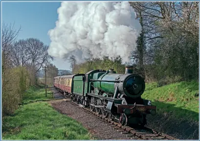  ?? JOHN TITLOW ?? With the first train from Kiddermins­ter to Bridgnorth on April 17, GWR 4-6-0 No. 6960 Raveningha­m Hall climbs the last few yards into Stanley Cutting approachin­g Highley.