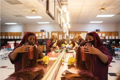  ?? Staff photo by Kelsi Brinkmeyer ?? ■ Liberty-Eylau senior DaMya Smith constructs a wig that she made for the cosmetolog­y program to donate to charity. The students will be working on the wigs for the next two weeks in order to donate them by Christmas.