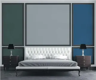  ??  ?? Judiciousl­y placed panels painted in shades of green, grey and blue, framed in black, form a striking backdrop for the bed in this tableau. The dark colours add a calming sense of cosiness.