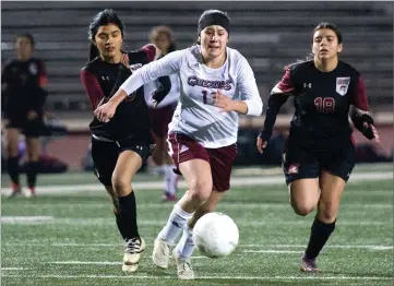  ?? RECORDER PHOTOS BY CHIEKO HARA ?? Granite Hills High School's Jamilex Vieyra, center, chases down the ball in front of the goal Wednesday during the first half against Cesar Chavez High School at Jacob Rankin Stadium in Portervill­e.