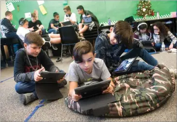  ?? RECORDER PHOTOS BY CHIEKO HARA ?? Parker Atikn, 12, left, Elijah Terrell, 11, and Joseph Gonzales 11, right, work on their projects Thursday during class at Summit Charter Academy Lombardi Campus.