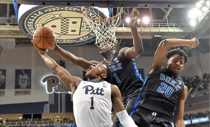  ?? Matt Freed/Post-Gazette ?? Duke’s Zion Williamson comes from behind to block a shot by Pitt’s Xavier Johnson in the first half Tuesday night at Petersen Events Center.