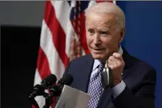  ?? Evan Vucci/Associated Press ?? President Joe Biden holds his face mask as he speaks during an event to commemorat­e the 50 millionth COVID-19 shot given in the U.S. on Thursday. Mr. Biden noted that that’s halfway to his promise of 100 million in 100 days.