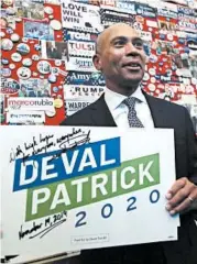  ?? CHARLES KRUPA/AP ?? Deval Patrick adds his campaign sign to pins, signs and stickers of current and past presidenti­al contenders on display in the State House visitors center in Concord, N.H.