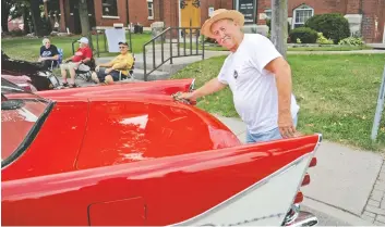  ?? [LIZ BEVAN / THE OBSERVER] ?? Bill Wilson shines up his red 1958 Desoto at the classic car show on Arthur Street on Aug. 5. The main street in Elmira was closed down for the afternoon and evening for the annual sidewalk sale.