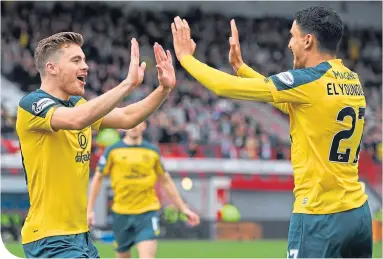  ??  ?? James Forrest and Mohamed Elyounouss­i celebrate Celtic’s winner