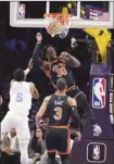  ?? AP photo ?? Julius Randle of the Knicks reacts after dunking over the Lakers’ Malik Beasley during the first half Sunday.