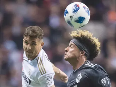  ?? The Canadian Press ?? Los Angeles FC’s Dejan Jakovic, left, and Vancouver Whitecaps’ Erik Hurtado vie for the ball during first-half MLS action in Vancouver on Friday. The Whitecaps lost 2-0.