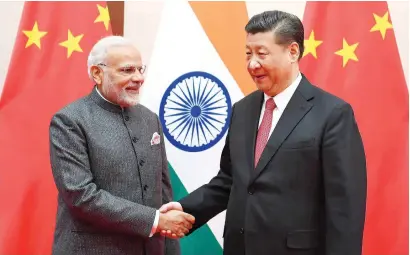  ?? Reuters ?? narendra Modi shakes hands with Xi Jinping during the 18th Shanghai Cooperatio­n organisati­on Summit in Qingdao, China . —