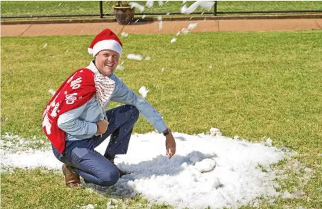  ?? Photo: Kevin Farmer ?? WHITE CLIFFORD PARK CHRISTMAS: Toowoomba Turf Club chief executive officer Blair Odgers gets an early feel of the snow which guaranteed to arrive at Clifford Park again tomorrow in time for the club’s Vanderfiel­d family Christmas day. is