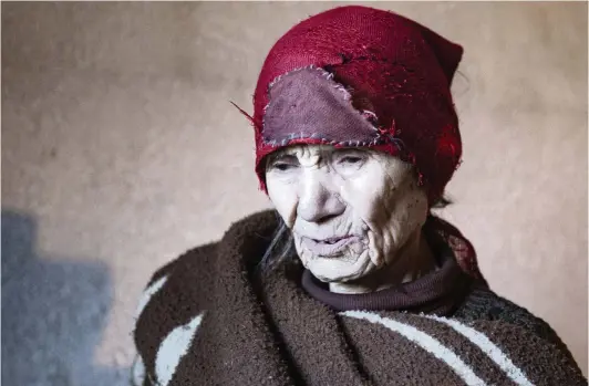  ?? VISAR KRYEZIU AP ?? Blagica Dicic, 92, an ethnic Serb, was left alone when all her former neighbors moved away fromVagane­sh, Kosovo. Fadil Rama, 54, an ethnic Albanian who comes from the other side of Kosovo’s bitter ethnic divide, is taking care of her.