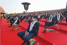  ?? — AFP ?? Gold medallist Neeraj Chopra (centre) along with other medallists of the Tokyo 2020 Olympic Games listen to the speech Prime Minister Narendra Modi (not pictured) at the Red Fort during the celebratio­ns to mark country’s 75th Independen­ce Day in New Delhi on Sunday.