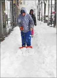  ?? TOM KELLY III — FOR DIGITAL FIRST MEDIA ?? Elijah Levan, a student at the Progressiv­e School in Pottstown, was seen in the 300 block of High Street shoveling snow off the sidewalks in the downtown business district. He told The Mercury he was walking downtown and shoveling for FREE any...