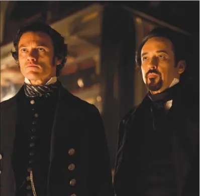  ??  ?? NEVERMORE: In this film publicity image released by Relativity Media, Luke Evans portrays Detective Fields , left, and John Cusack portrays Edgar Allan Poe in a scene from the gothic thriller “The Raven.”