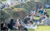  ?? JAMES HILL/THE NEW YORK TIMES ?? People enjoy warm weather Wednesday in Paris. With a new wave of infections battering France, President Emmanuel Macron announced the country’s third lockdown starting Saturday.