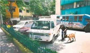  ??  ?? BOMB THREAT – Bomb-sniffing dogs check vehicles parked at the Cebu City health office after a bomb threat message was sent to the office’s Facebook page Saturday. No explosive device was found, and the message was traced to a resident of Barangay...