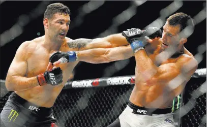  ??  ?? John Locher The Associated Press Chris Weidman, left, began his three-bout skid in December 2015 when he lost to Luke Rockhold at UFC 194.