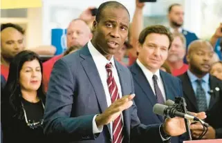  ?? CHRIS O’MEARA/AP ?? Florida Surgeon General Dr. Joseph Ladapo speaks to supporters and members of the media before a bill signing by Gov. Ron DeSantis on Nov. 18, 2021, in Brandon. Ladapo is drawing criticism for his handling of an elementary school’s measles outbreak.