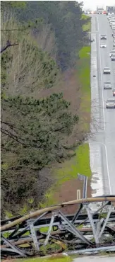  ??  ?? The winds toppled communicat­ions towers in Alabama’s Lee County, blocking traffic for hours.