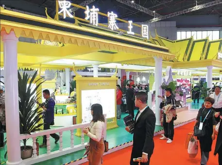  ?? CHEN FEI / XINHUA ?? Visitors walk past the Cambodian pavilion during the second China Internatio­nal Import Expo in Shanghai on Nov 6, 2019.